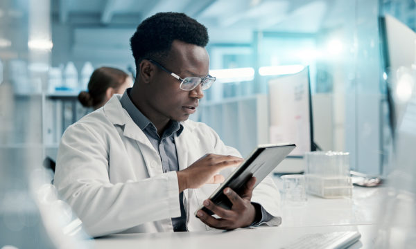 men looking at a tablet in a clinical setting